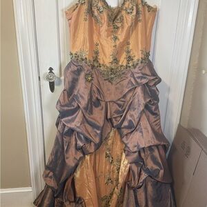 Quinceañera dress gold, green and purple in color.